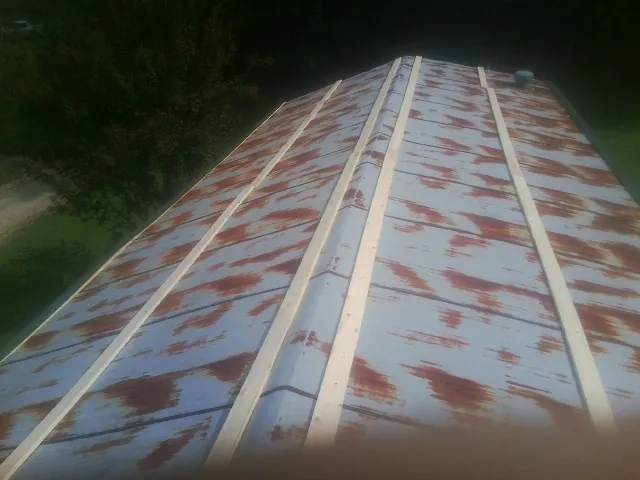 Rusted metal roof panels with new wood purlins before replacement — Storm Damage Roof Repair in New Palestine by Roofing Brothers