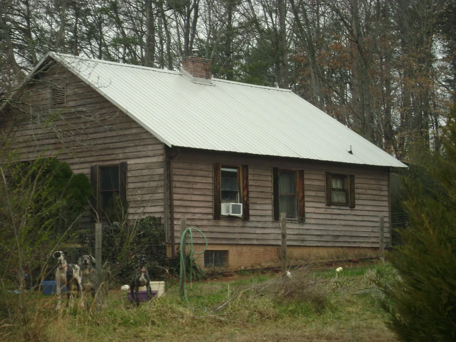 White metal roof on an old wood sided farmhouse, from a Metal Roof Installation job in New Palestine